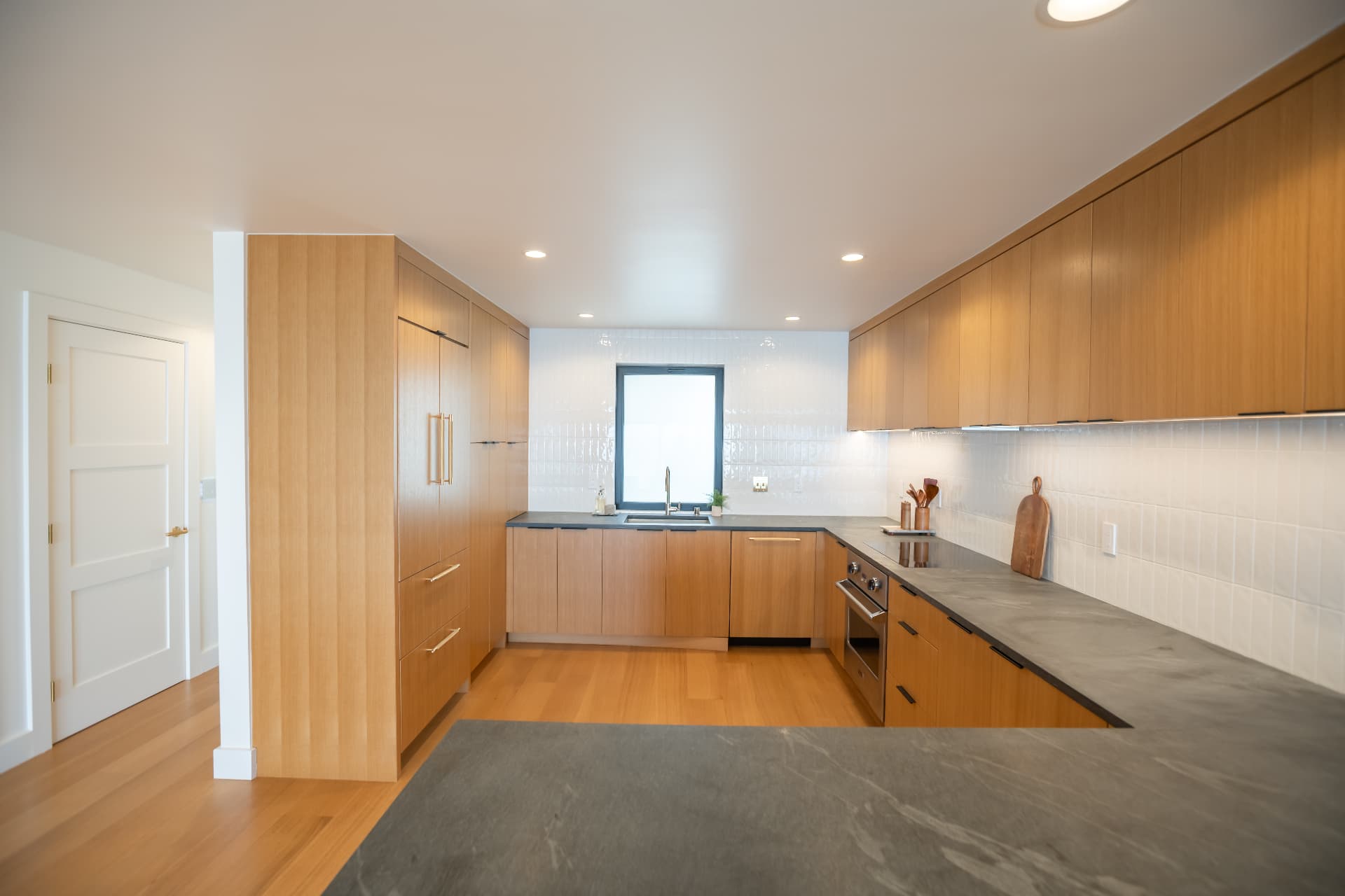 Full kitchen with stone counters