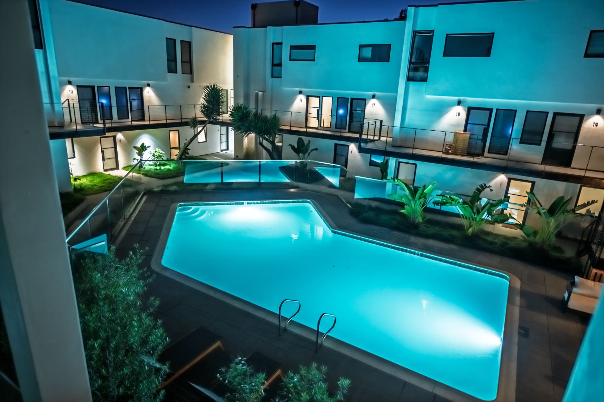 The shared pool and courtyard at night