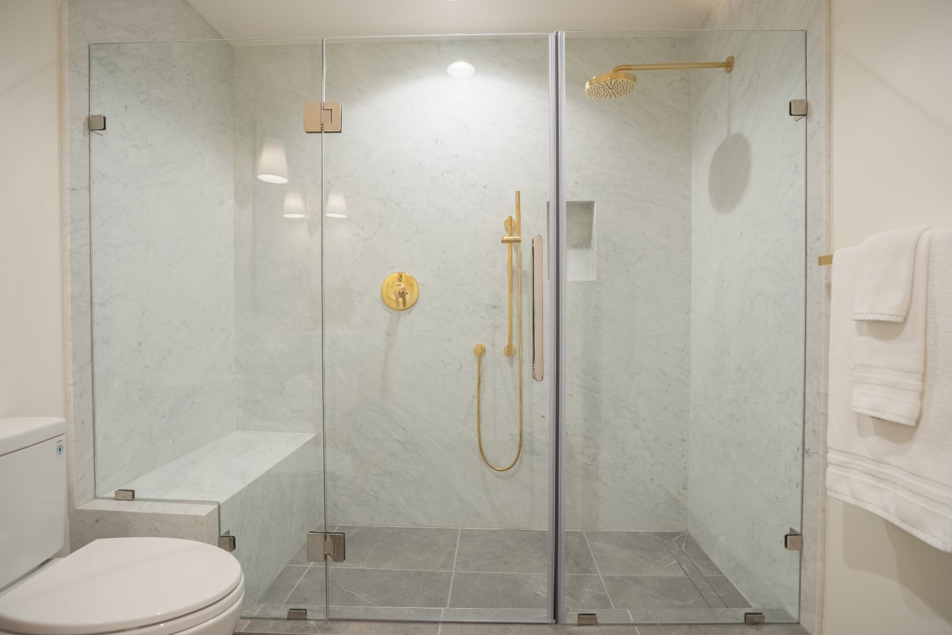 Marble shower with brass fixtures